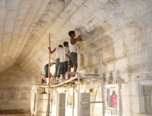 Traditional masons cleaning the marble surface